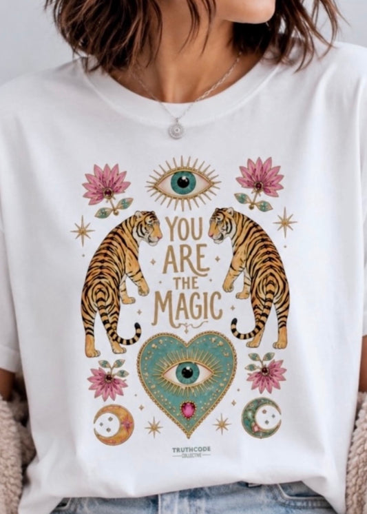 White t-shirt with tiger design and text 'You are the magic' on a white background