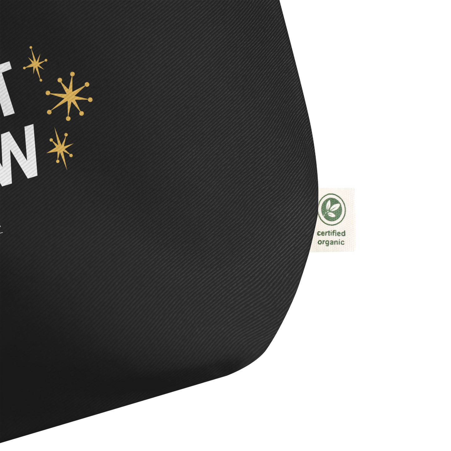 Close view of black organic tote with a  certified organic label on a white background