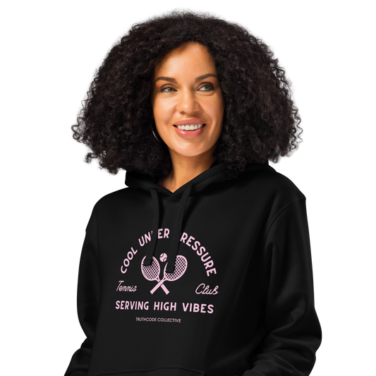 Woman wearing black organic hoodie with text 'Cool under pressure, serving high vibes' and 'Tennis club' with a tennis racket design on a white background
