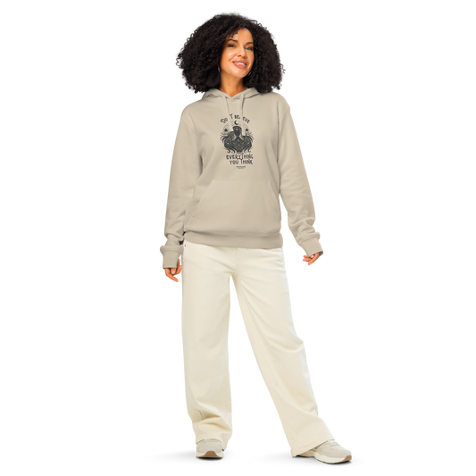Woman wearing beige organic hoodie with cosmic woman graphic design and text 'Don't believe everything you think' on a white background