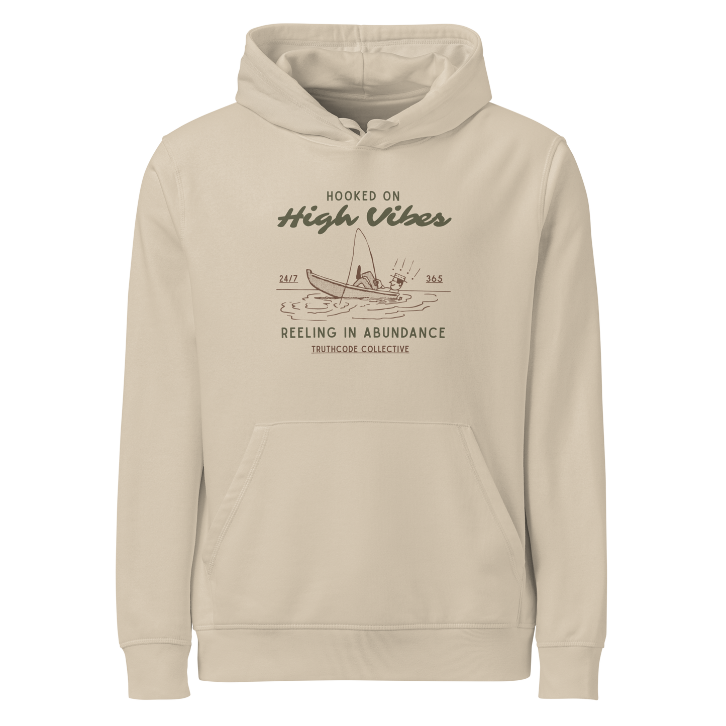 Beige organic hoodie with text 'Hooked on High Vibes, reeling in abundance' and graphic design of a fishing boat on a white background