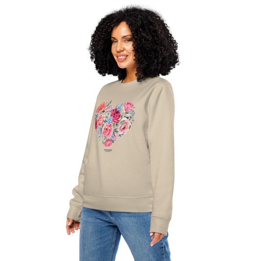 Woman wearing beige organic sweatshirt with a floral heart design on a white background