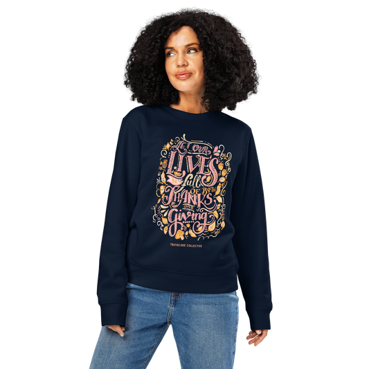 Woman wearing navy blue organic sweatshirt with colorful text design 'Let our lives be full of both thanks and giving' on a white background