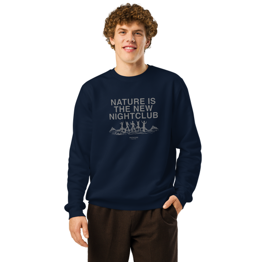 Person wearing a navy blue organic sweatshirt with text 'Nature is the new nightclub' and graphic design with a white background