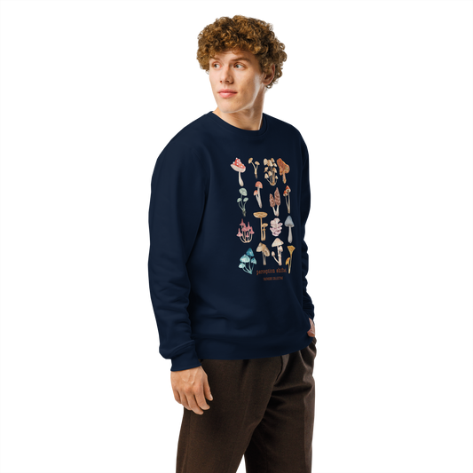 Guy wearing navy blue organic sweatshirt with colorful mushroom illustrations and text 'Perception shifted' on a white background