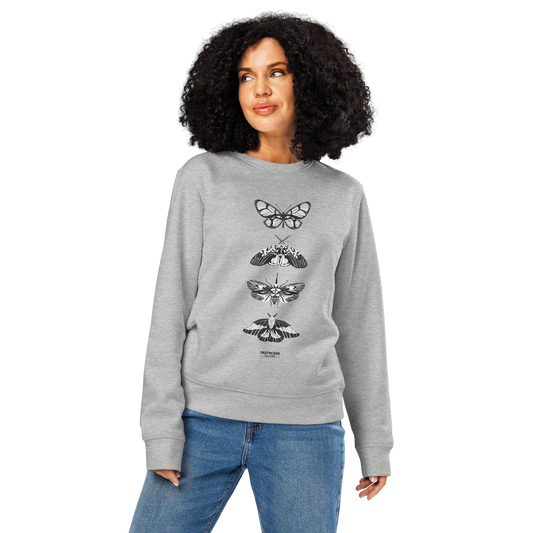 Woman wearing gray organic sweatshirt with various butterfly designs on a white background