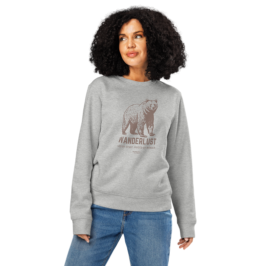 Woman wearing gray organic sweatshirt with bear graphic and 'Wanderlust' text on a white background