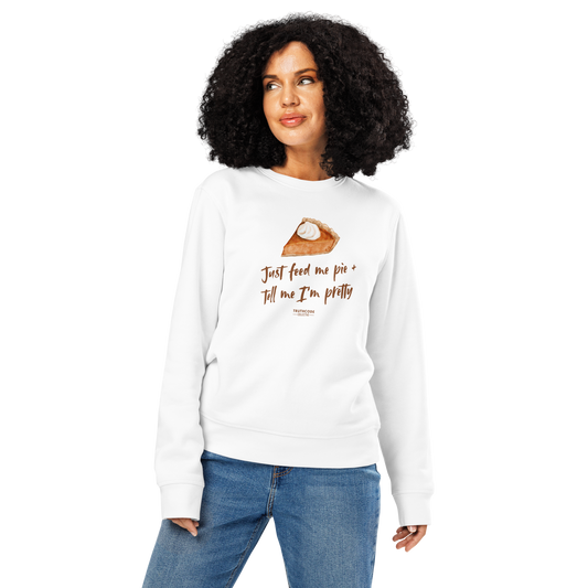 Woman wearing white organic sweatshirt with a pie graphic and text 'Just feed me pie and tell me I'm pretty' on a white background