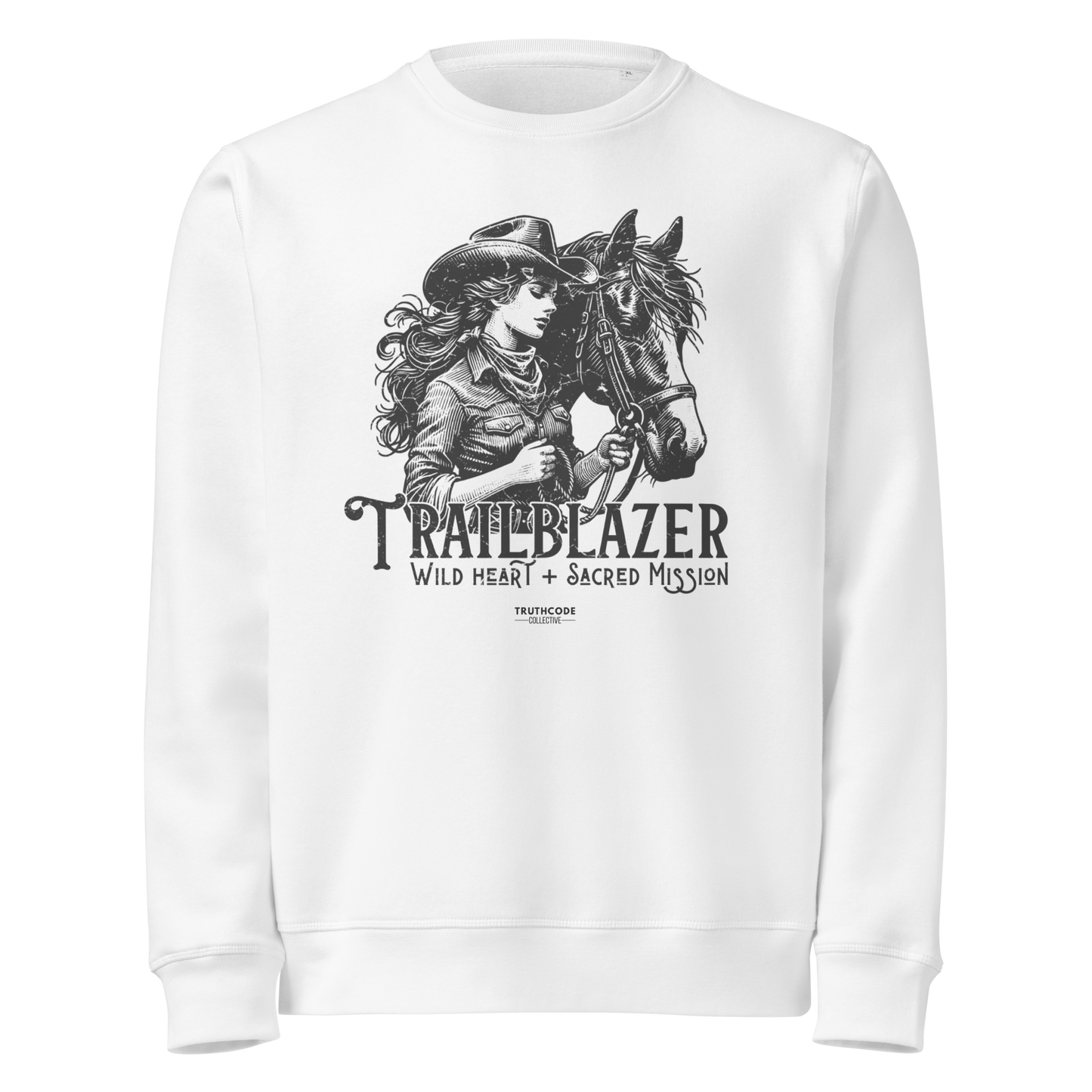White organic sweatshirt with graphic of a woman holding a horse and text 'Trailblazer' and 'Wild heart, sacred mission' on a white background