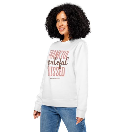 Woman wearing white organic sweatshirt with 'Thankful grateful BLESSED' text on a white background