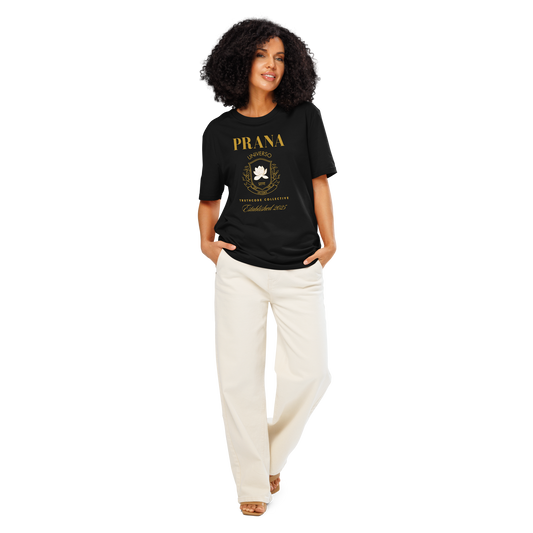 Woman wearing black organic t-shirt with gold 'Prana' crest design on a white background