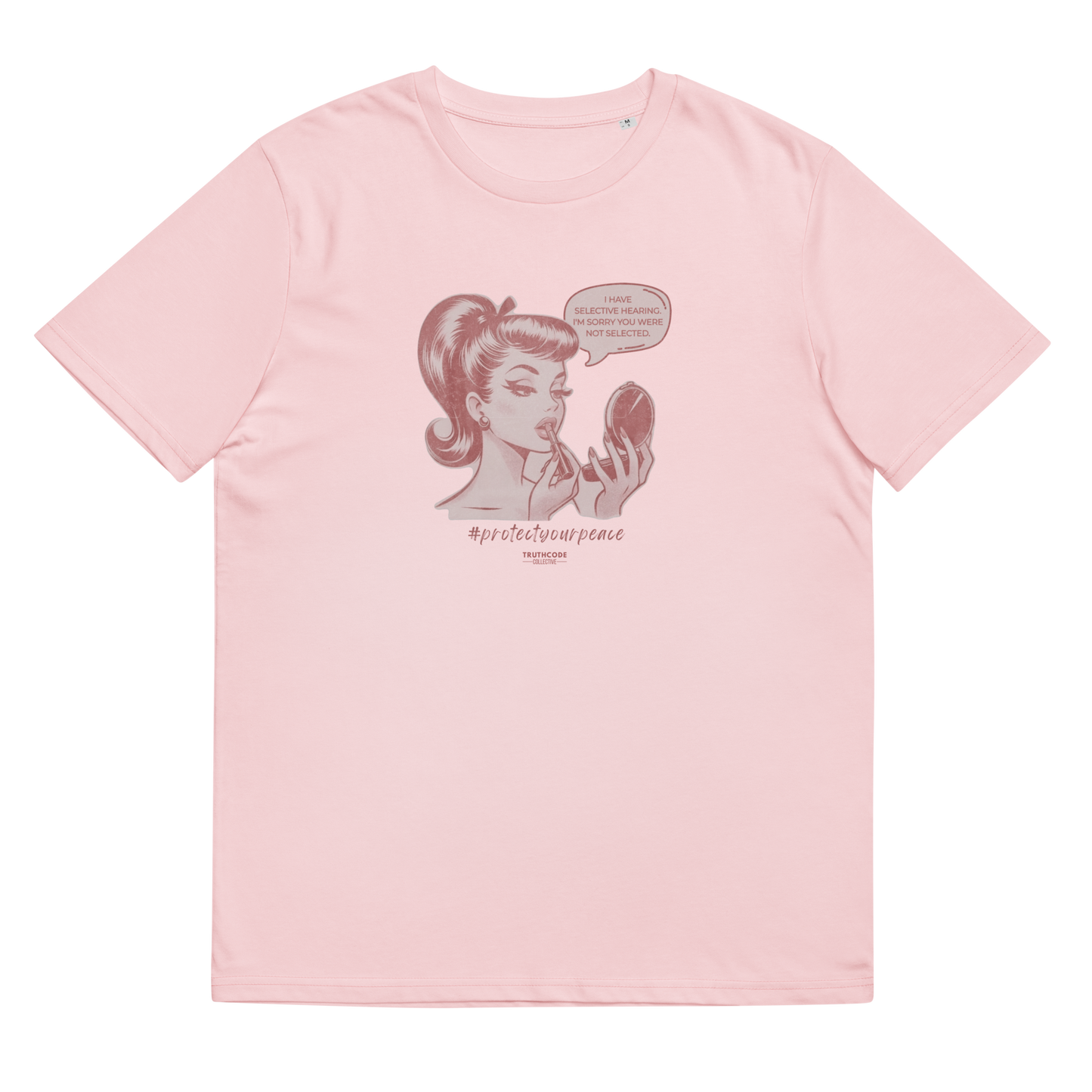 Pink organic t-shirt with a vintage style graphic of a woman looking at herself in a mirror and the text 'I have selective hearing. I'm sorry your were not selected', shirt on a white background