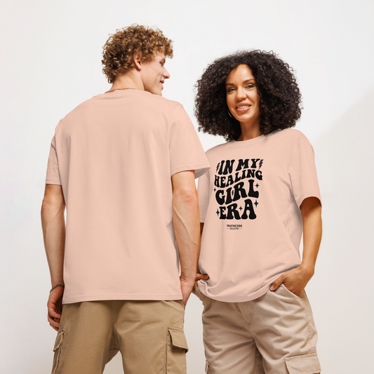 Models wearing peach organic t-shirt with black text 'IN MY HEALING GIRL ERA' on a white background