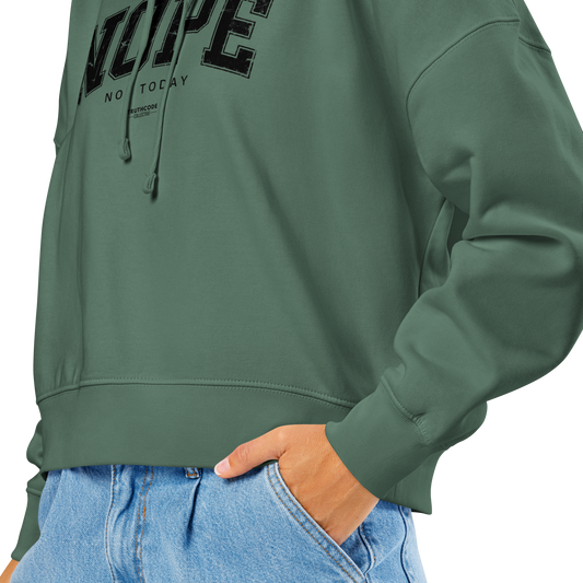 Green organic hoodie with text and blue jeans. Image showing the cut of the hoodie lands at the waist. On a white background