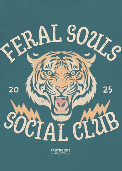 Close view of teal organic t-shirt with a tiger graphic and text 'Feral Souls Social Club' against a white background