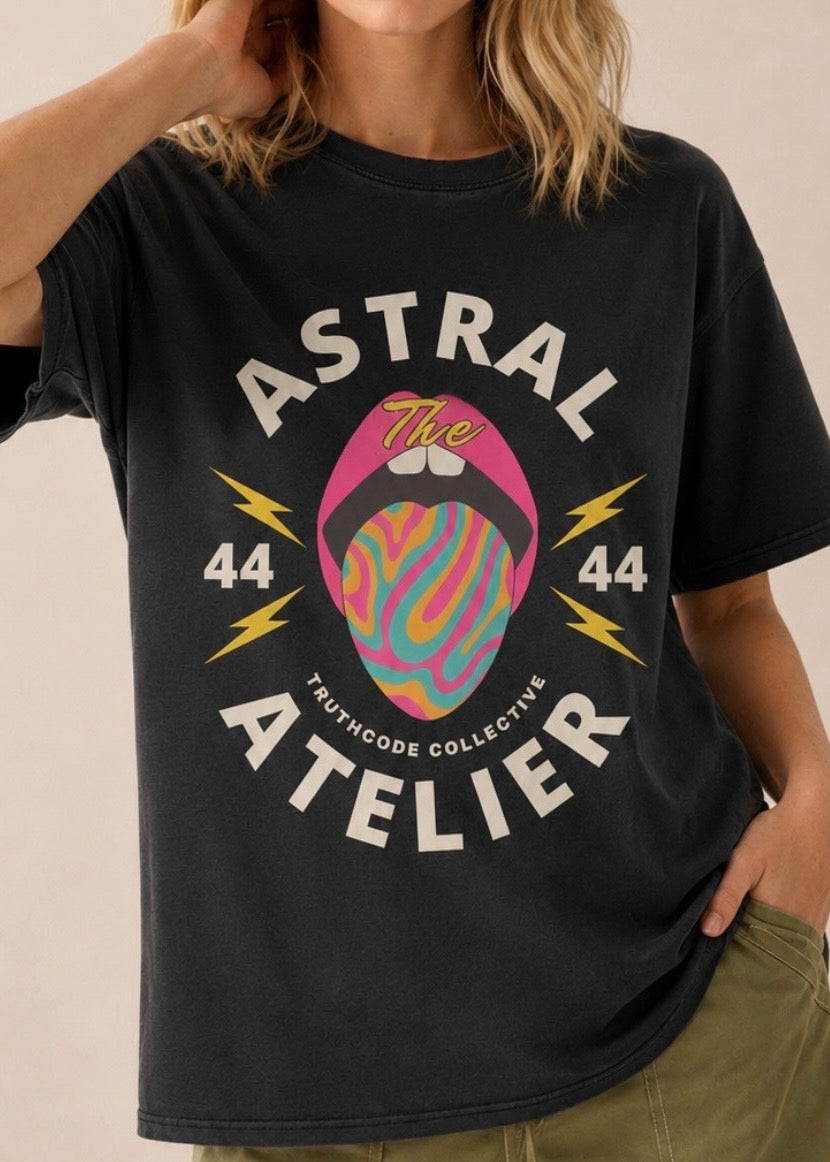 Person wearing a black t-shirt with 'Astral Atelier' graphic design. Angel number 4444