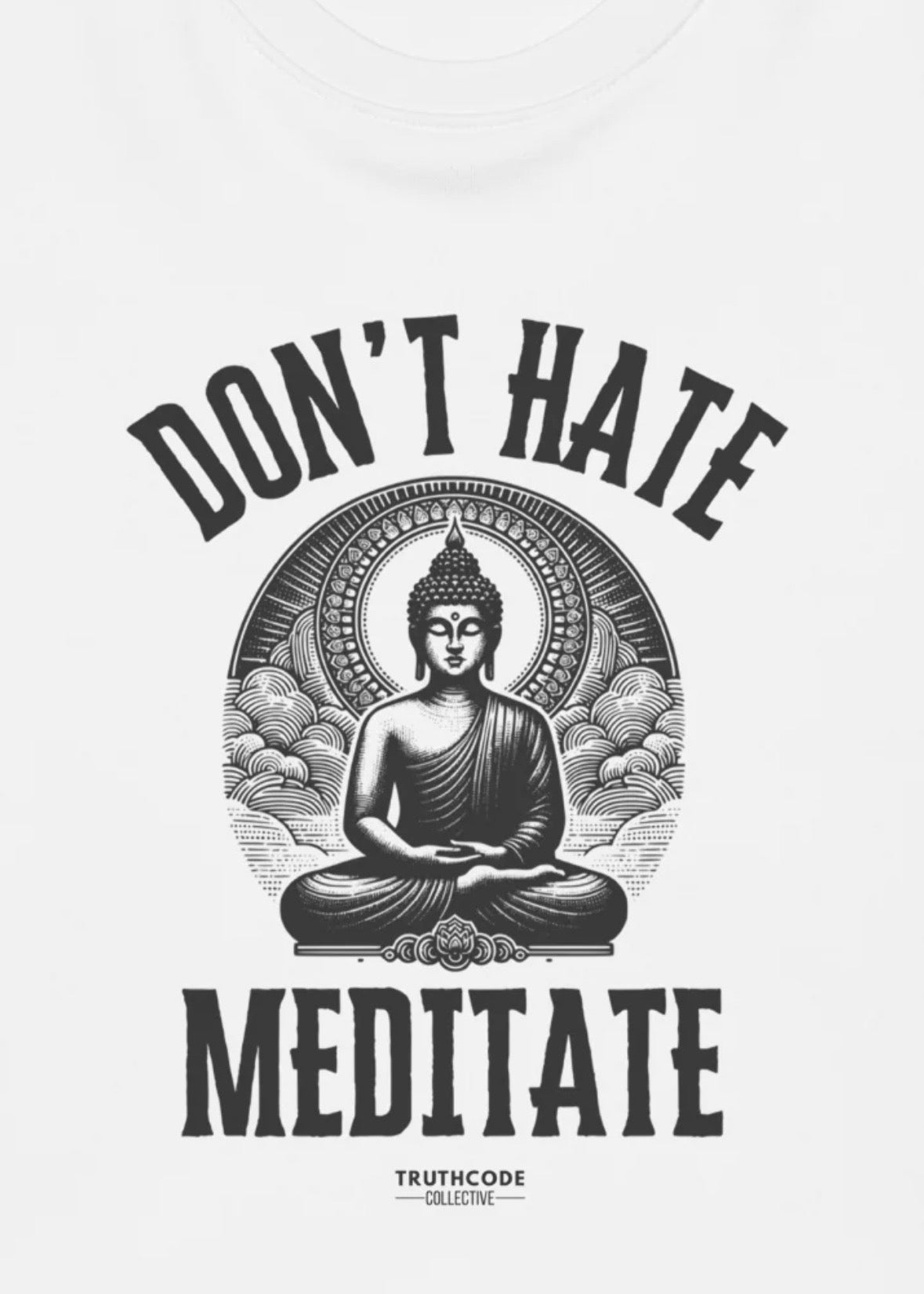 Close view of white t-shirt with black and white graphic of Buddha image and 'Don't Hate Meditate' text