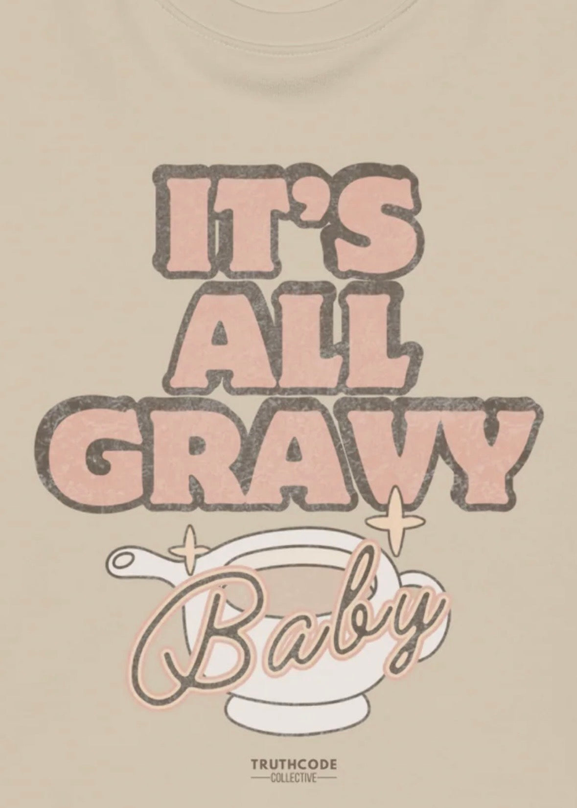 Close view of beige t-shirt with 'It's All Gravy Baby' text and a gravy boat graphic, on a white background