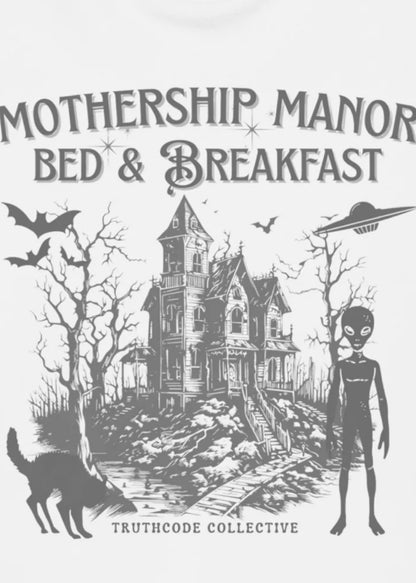 Illustration of a haunted house labeled 'Mothership Manor Bed & Breakfast' with an alien figure and bats on a white sweatshirt background.