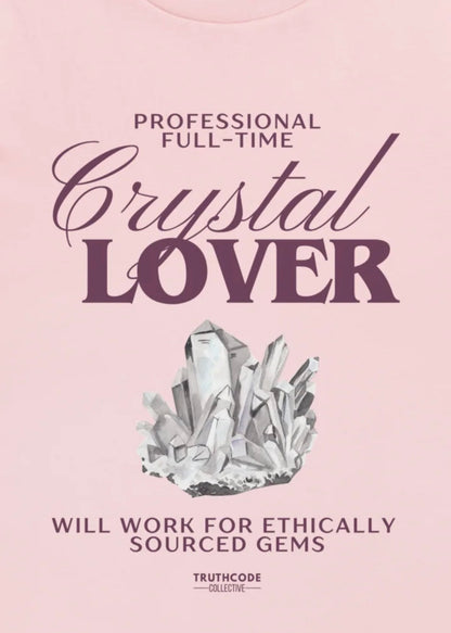 Close view of pink t-shirt with text 'Professional Full-Time Crystal Lover' and 'Will work for ethically sourced gems' and crystal graphic 