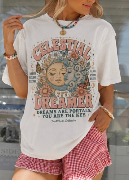 Person wearing a white t-shirt with 'Celestial Dreamer' design and red checkered shorts. Also included in design is 'Dream Believe Become',  'Align Ascend Receive, and angel number 777.