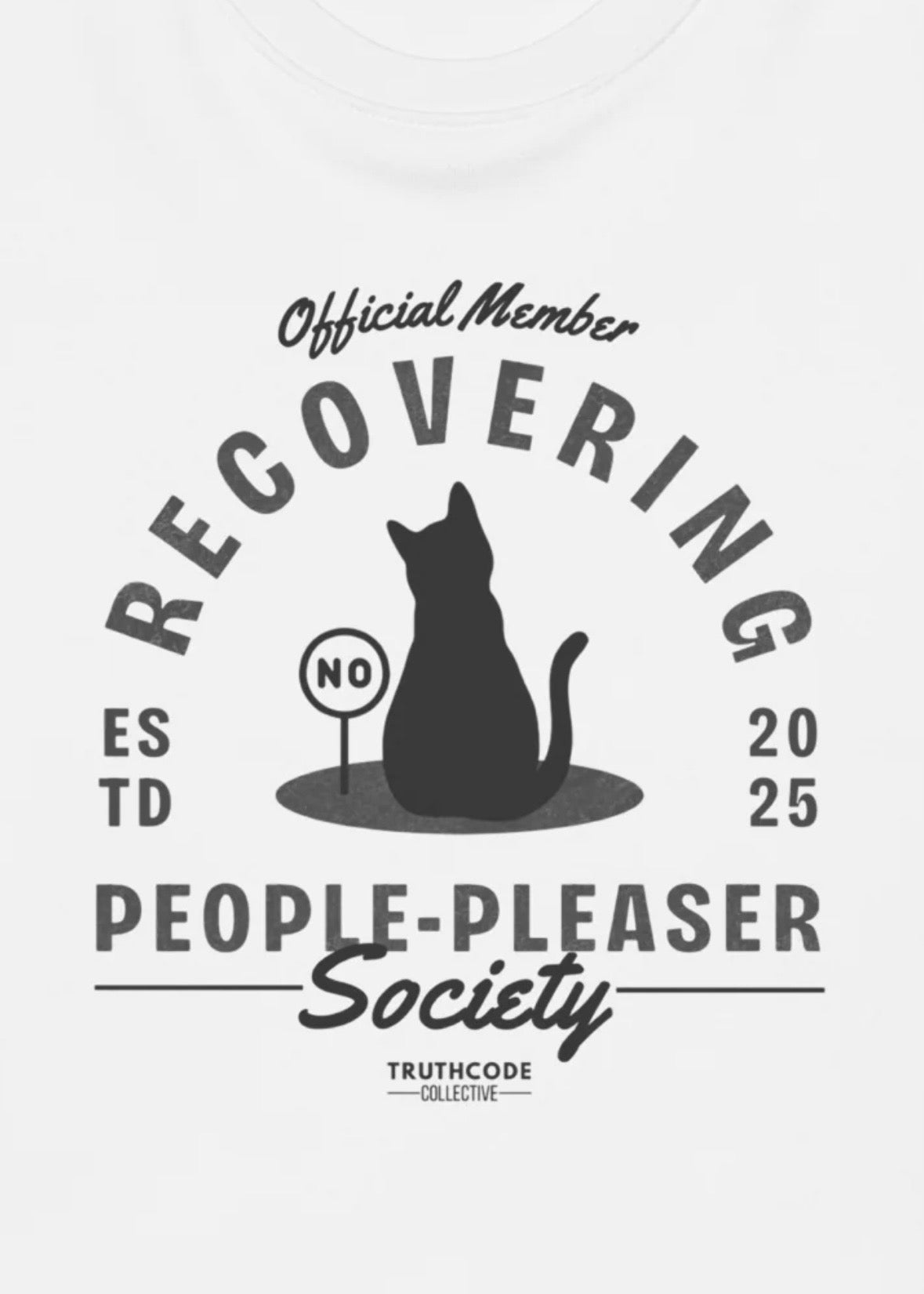 Close view of white t-shirt with graphic design of a black cat and text 'Recovering People-Pleaser Society'