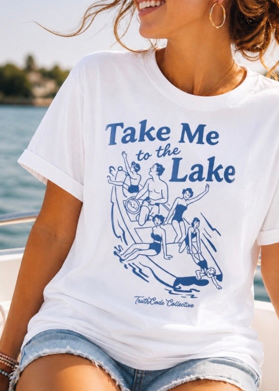 Woman wearing a white t-shirt with 'Take Me to the Lake' graphic design.