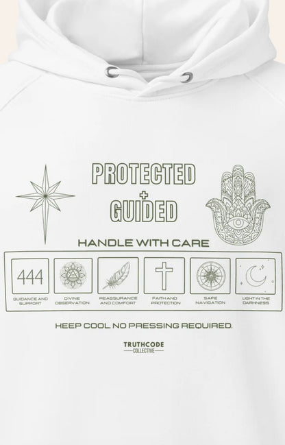 Close view of white hoodie with laundry tag style graphic design and text 'Protected + Guided' and suymbols relating to protection