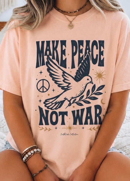Person wearing a peach t-shirt with 'Make Peace Not War' design