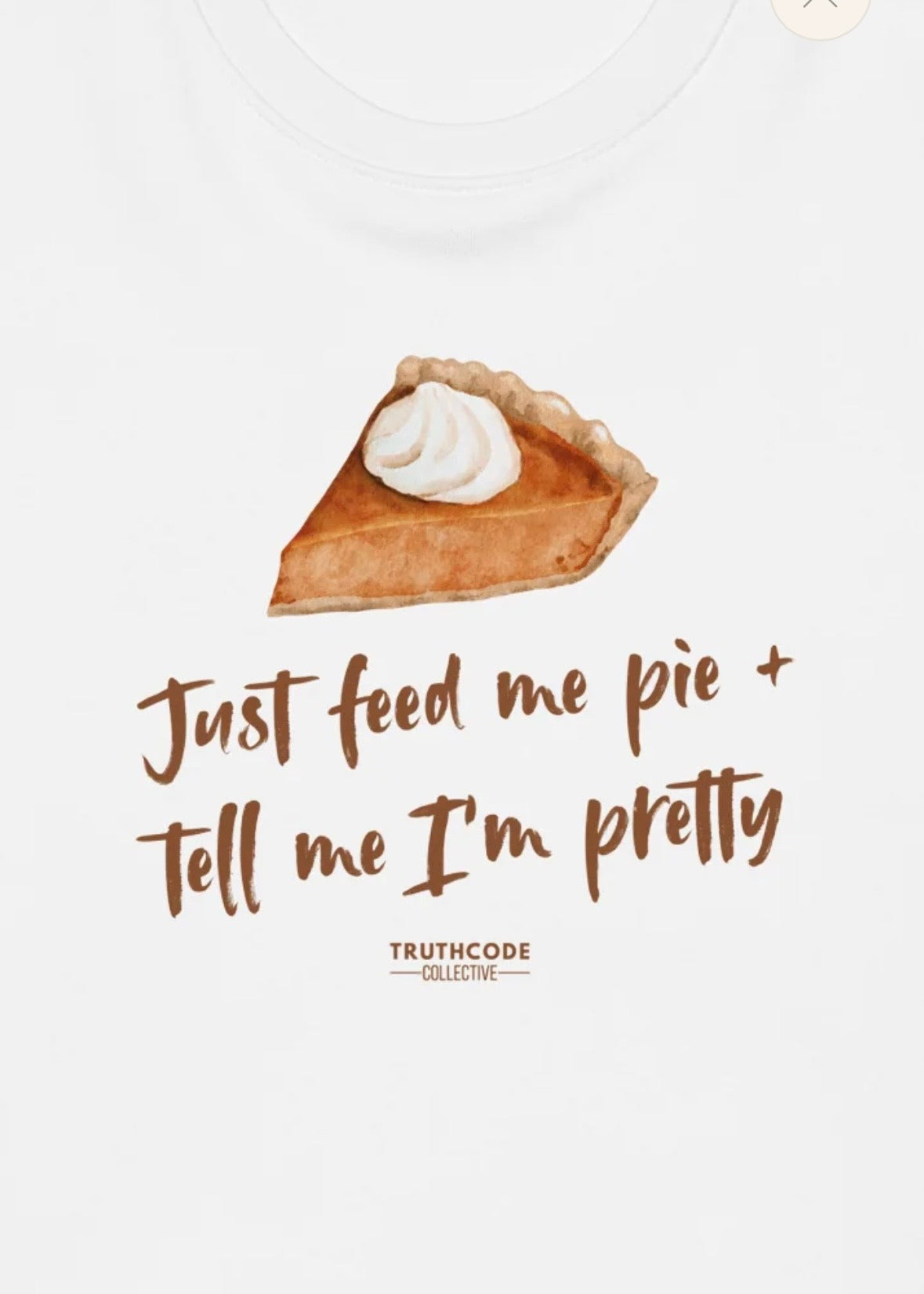 Close view of white organic sweatshirt with a pie graphic and text 'Just feed me pie and tell me I'm pretty' on a white background