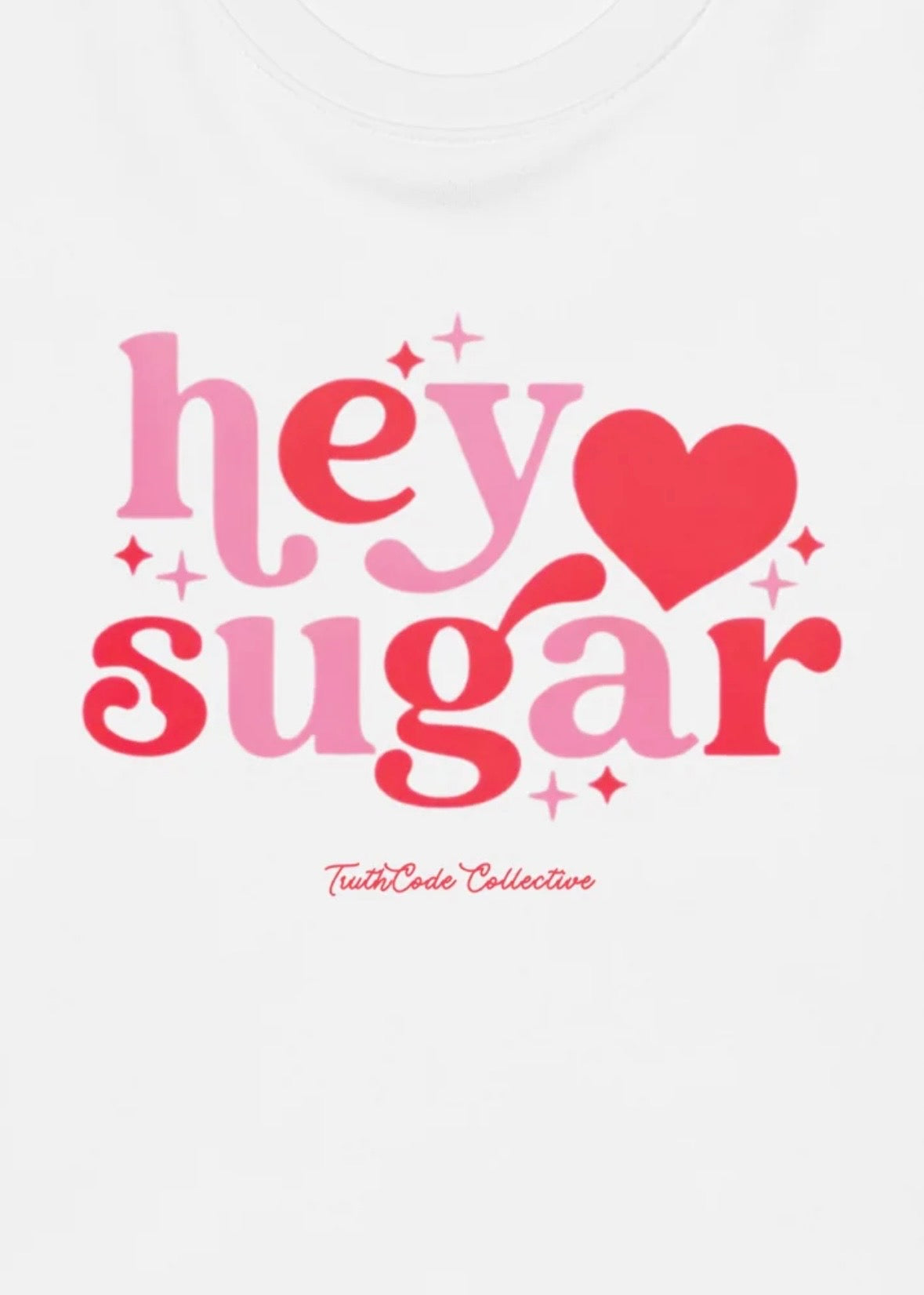 Close view of white t-shirt with text 'hey sugar' with a heart and star graphics
