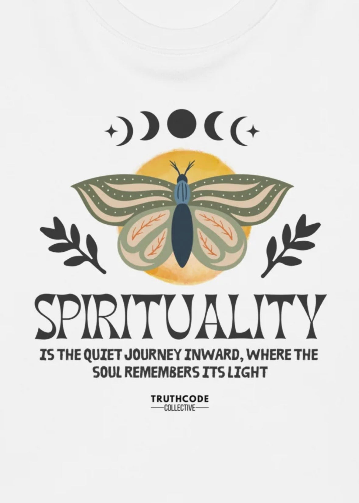 Close view of white t-shirt with graphic design of a butterfly design with text 'Spirituality, is the quiet journey inward, where the soul remembers it's light' 