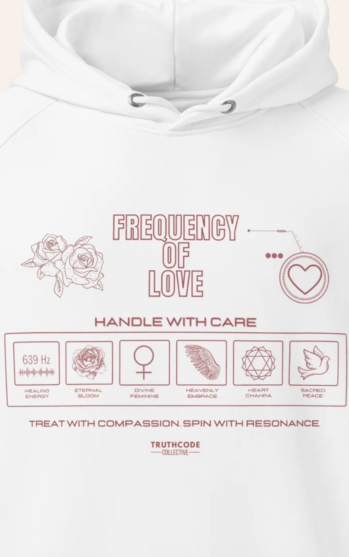 Close view of white hoodie with 'Frequency of Love' design and graphics relating to love in a laundry tag style design