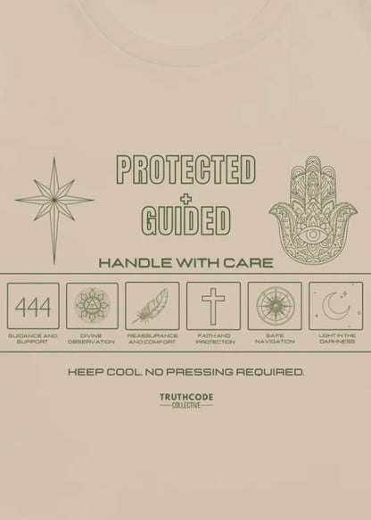 Close view of beige tee with laundry tag inspired design showing symbols relating to prtoection and text 'Protected + Guided' and 'Keep cool no pressing required'