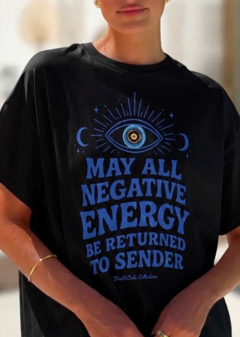 Person wearing a black t-shirt with blue text and evil eye design. Text reads 'may all negative energy be returned to sender'.