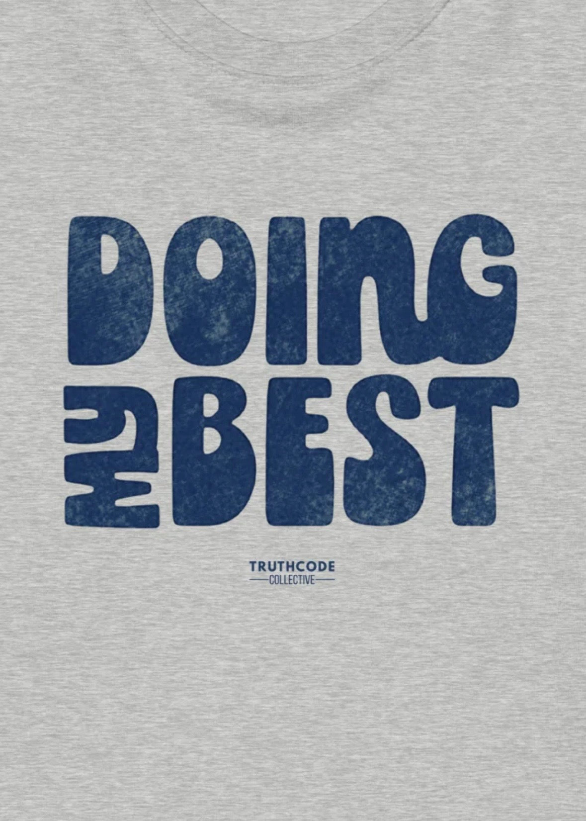Close view of gray t-shirt with blue 'DOING MY BEST' text and Truthcode Collective