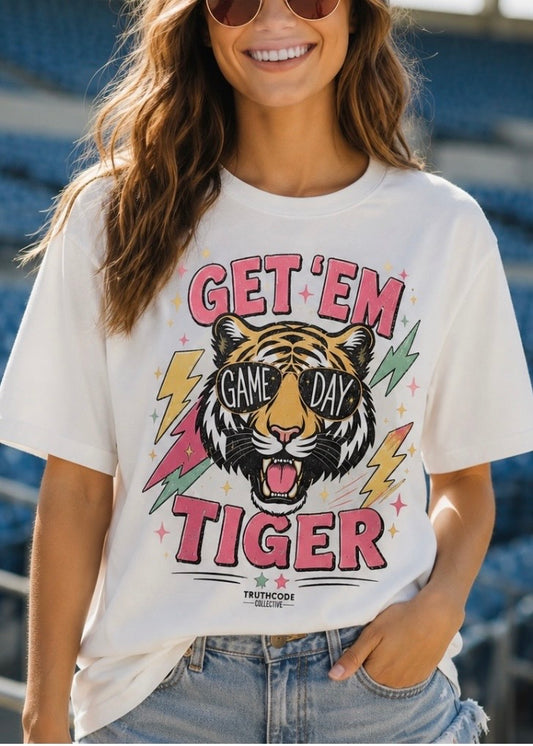 Person wearing a cute colorful 'Get 'em Tiger' and "Game Day' t-shirt with a tiger and lightning bolts graphic.