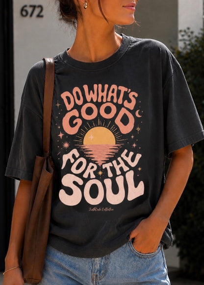 Person wearing a black t-shirt with a motivational quote, standing outdoors. Te says 'do what's good for the soul'. 