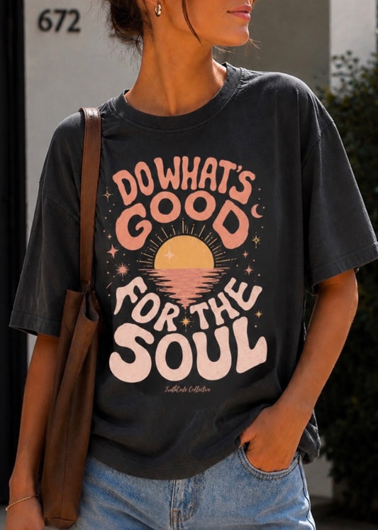 Person wearing a black t-shirt with a motivational quote, standing outdoors. Te says 'do what's good for the soul'. 