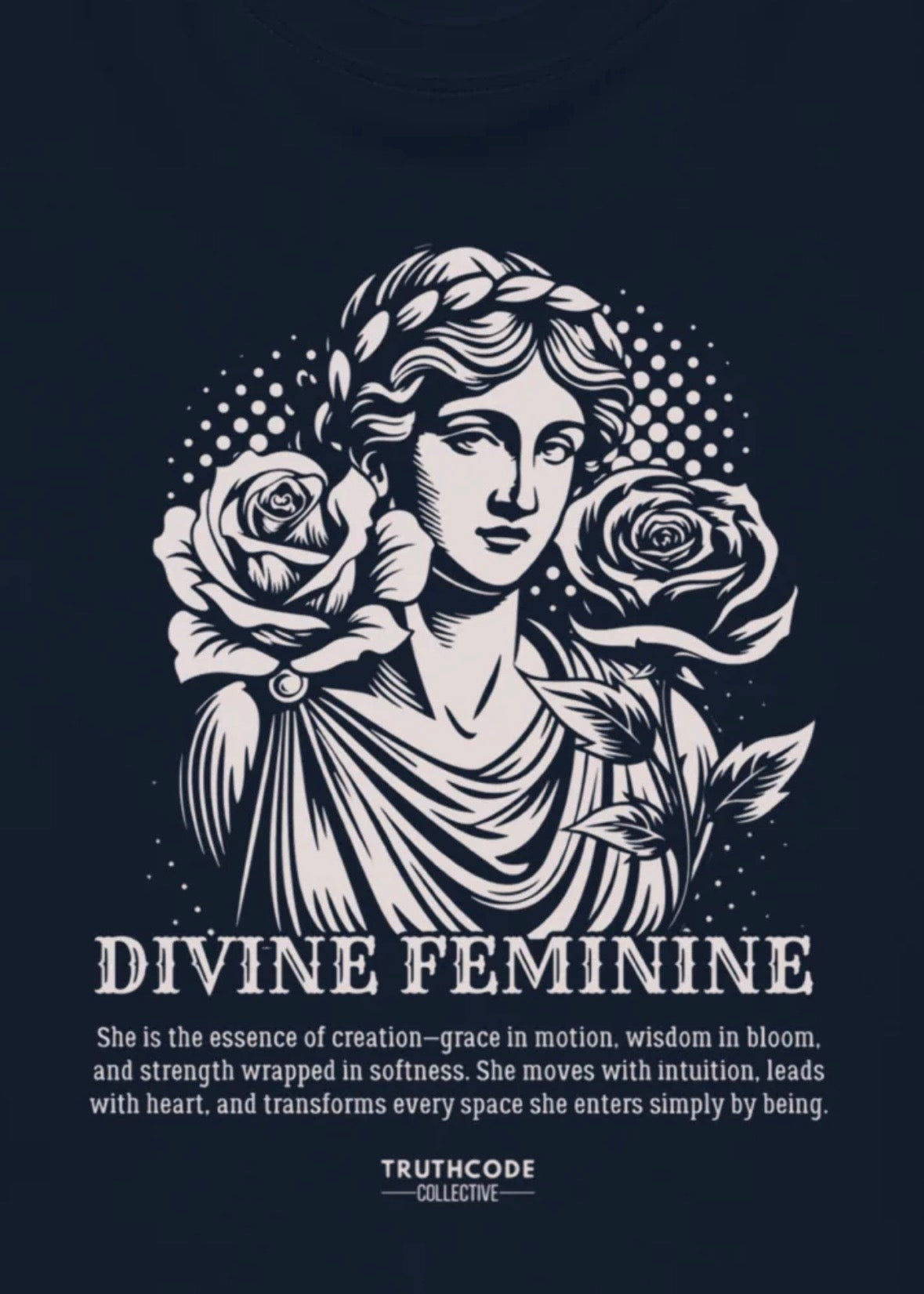 Close view of a navy blue t-shirt with an illustration of a classical woman holding roses with text about the 'Divine Feminine' 