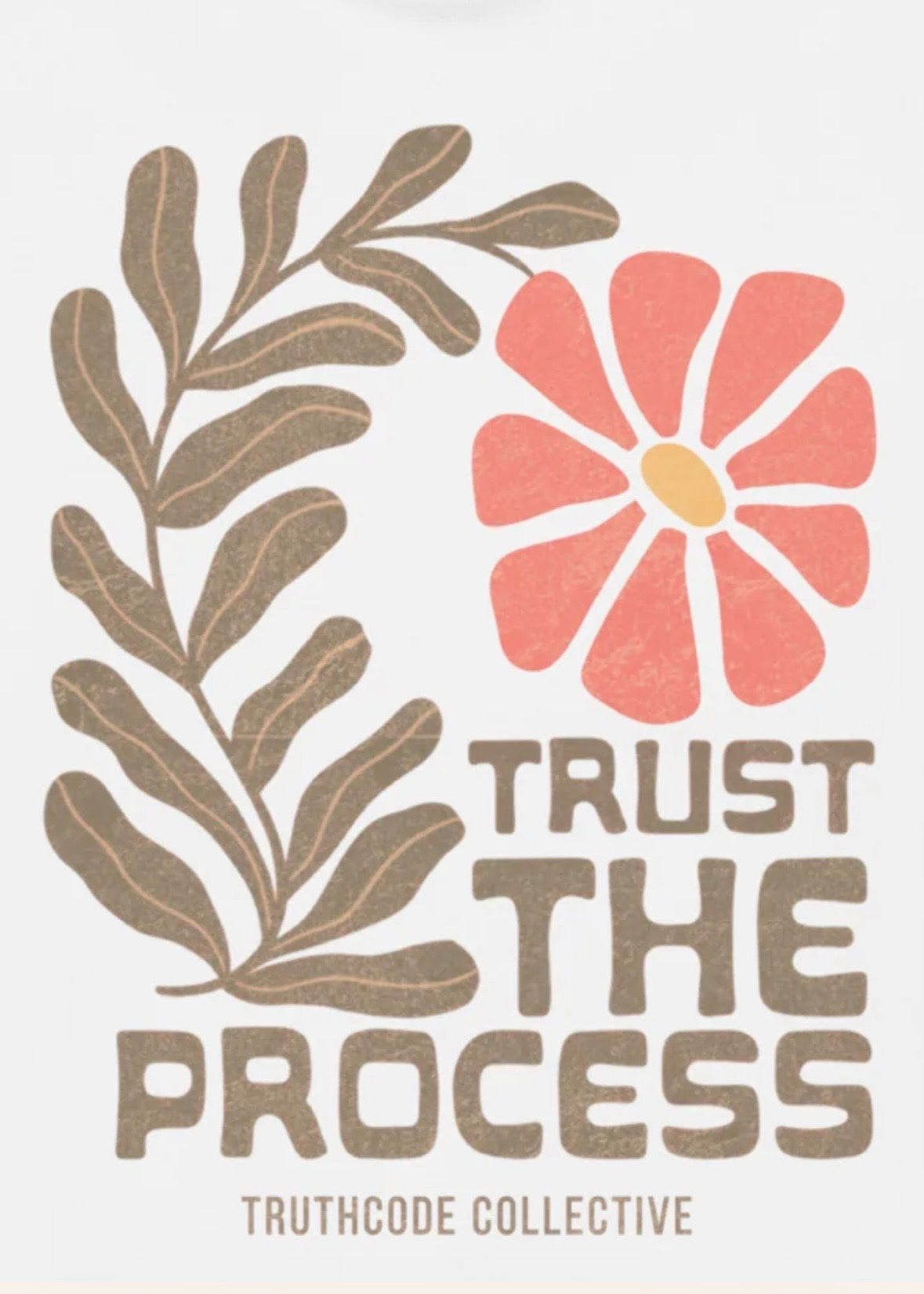 Close view of with t-shirt with floral design and text 'Trust The Process' text 