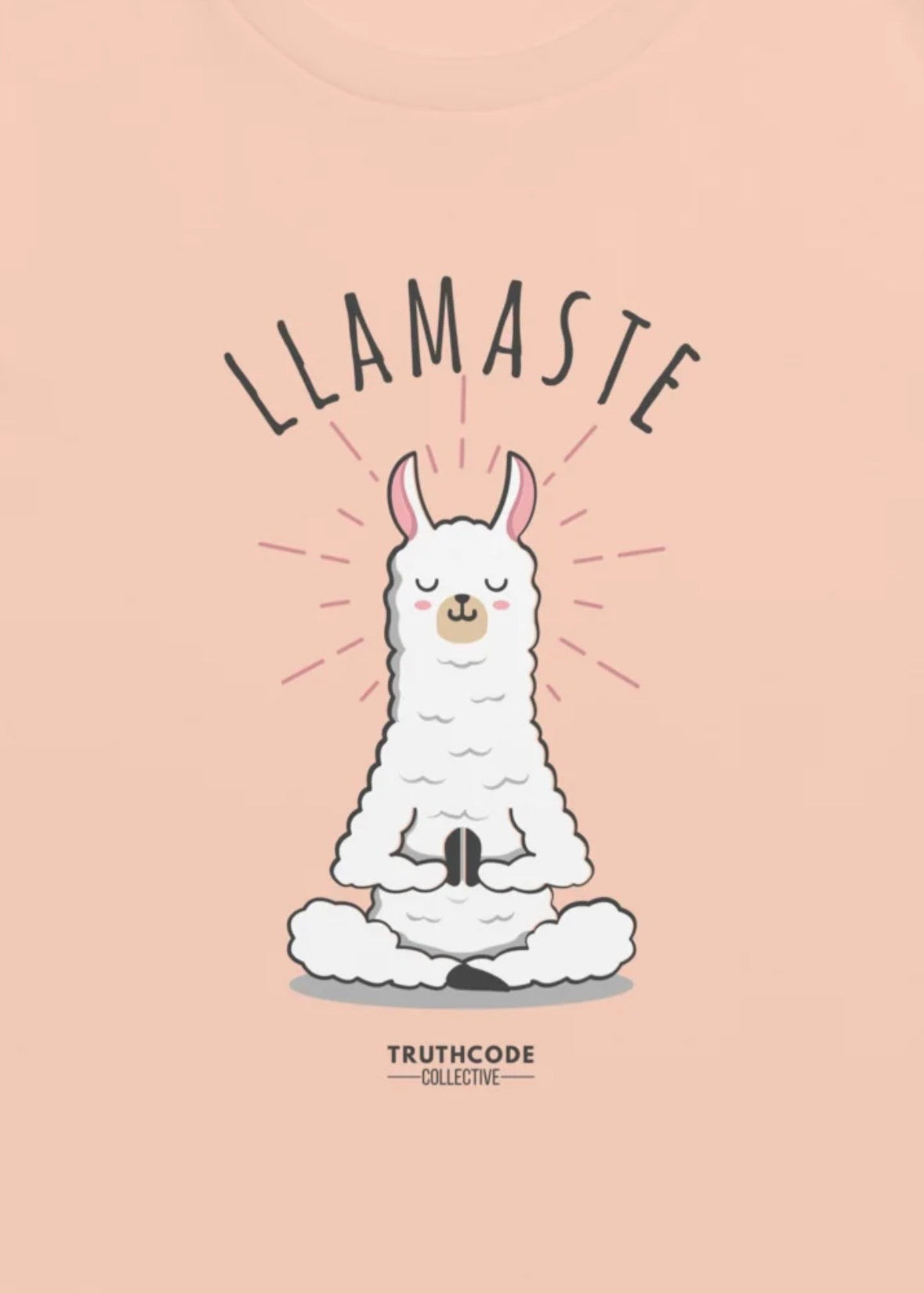 Close view of a peach t-shirt with a graphic design of a meditating llama with 'LLAMASTE' text 