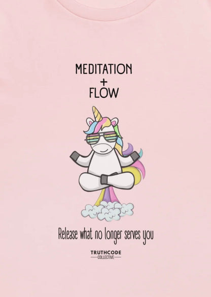 Close view of pink t-shirt with a cartoon unicorn and rainbow fart with text 'Meditation + Flow, release what no longer serves you'