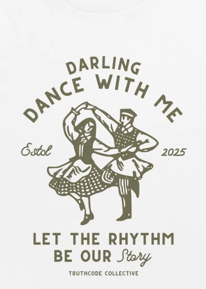 Close view of white t-shirt with vintage-style dance illustration with text 'Darling Dance With Me' and 'Let the Rhythm Be Our Story' 