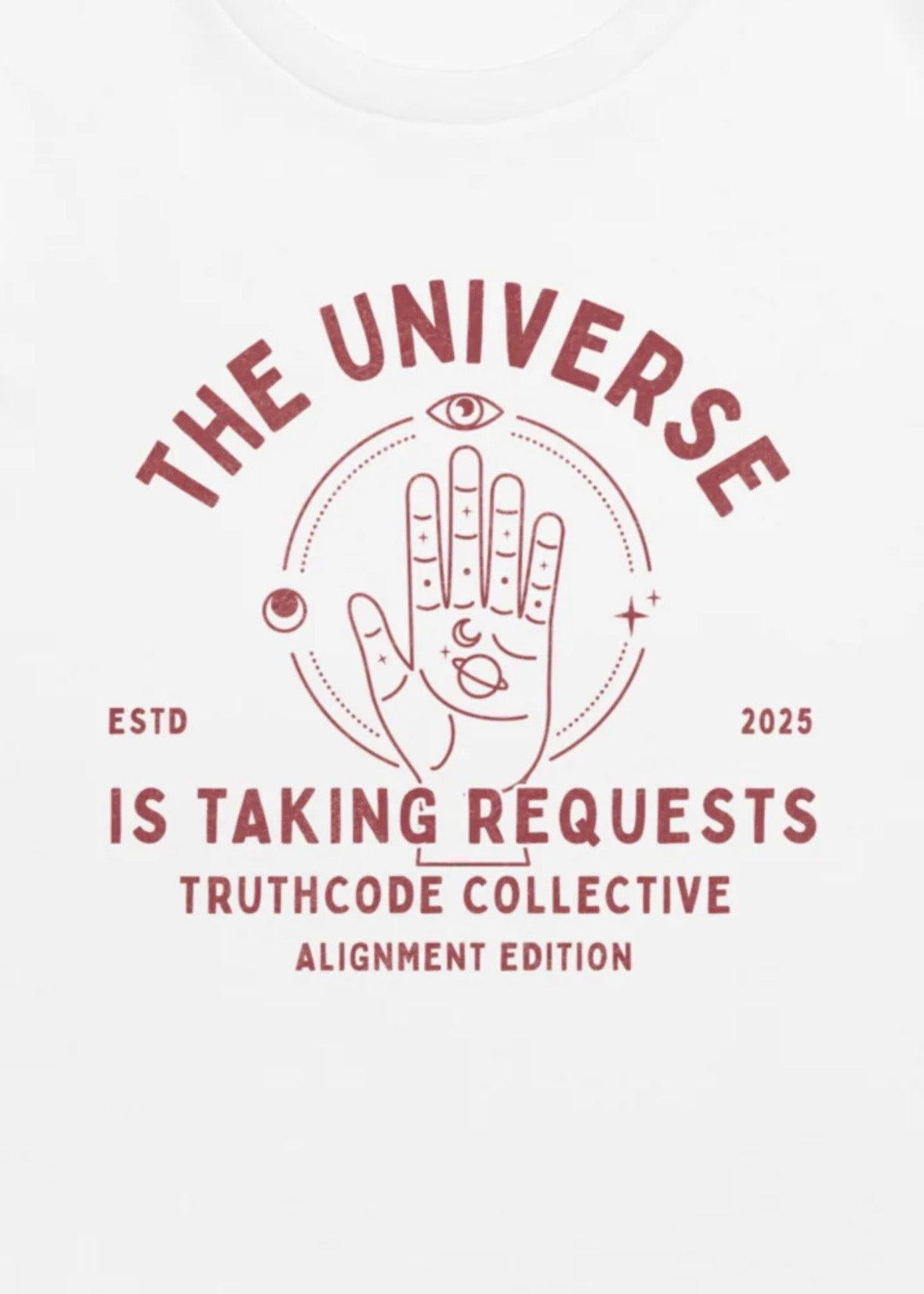 Close view of a white t-shirt with graphic design of hand-drawn palmistry illustration and text 'The universe is taking requests.'