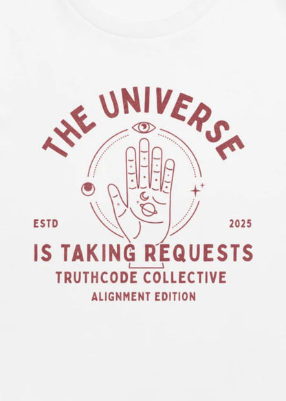 Close view of a white t-shirt with graphic design of hand-drawn palmistry illustration and text 'The universe is taking requests.'