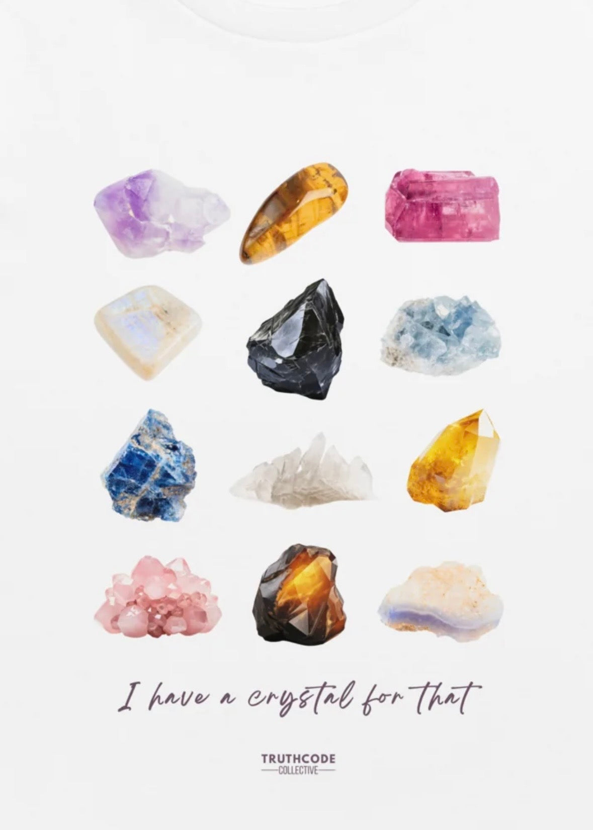 Close view of white organic t-shirt with colorful gemstone graphic and text 'I have a crystal for that' against a white background