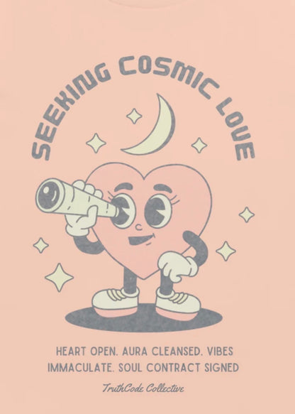 Close view of graphic design of heart character with a telescope on a pink background with text 'Seeking Cosmic Love' and 'Heart open. Aura cleansed. Vibes immaculate. Soul contract signed.'