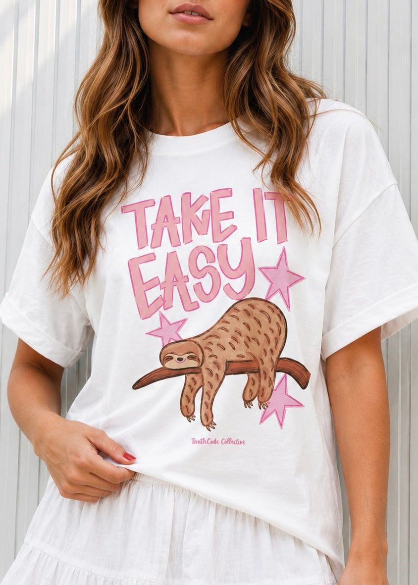 Person wearing a white t-shirt with a sloth graphic and 'Take It Easy' text.