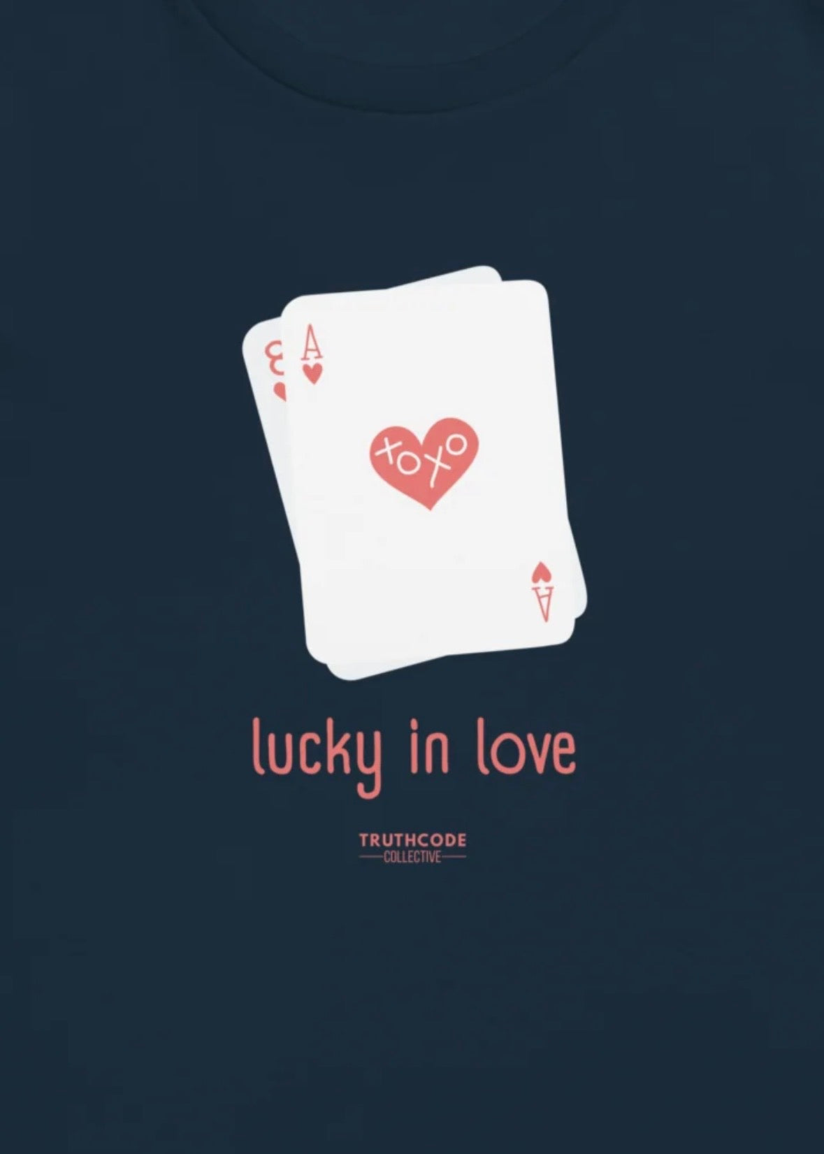 Close view of navy blue t-shirt with a playing card design and 'lucky in love' text 